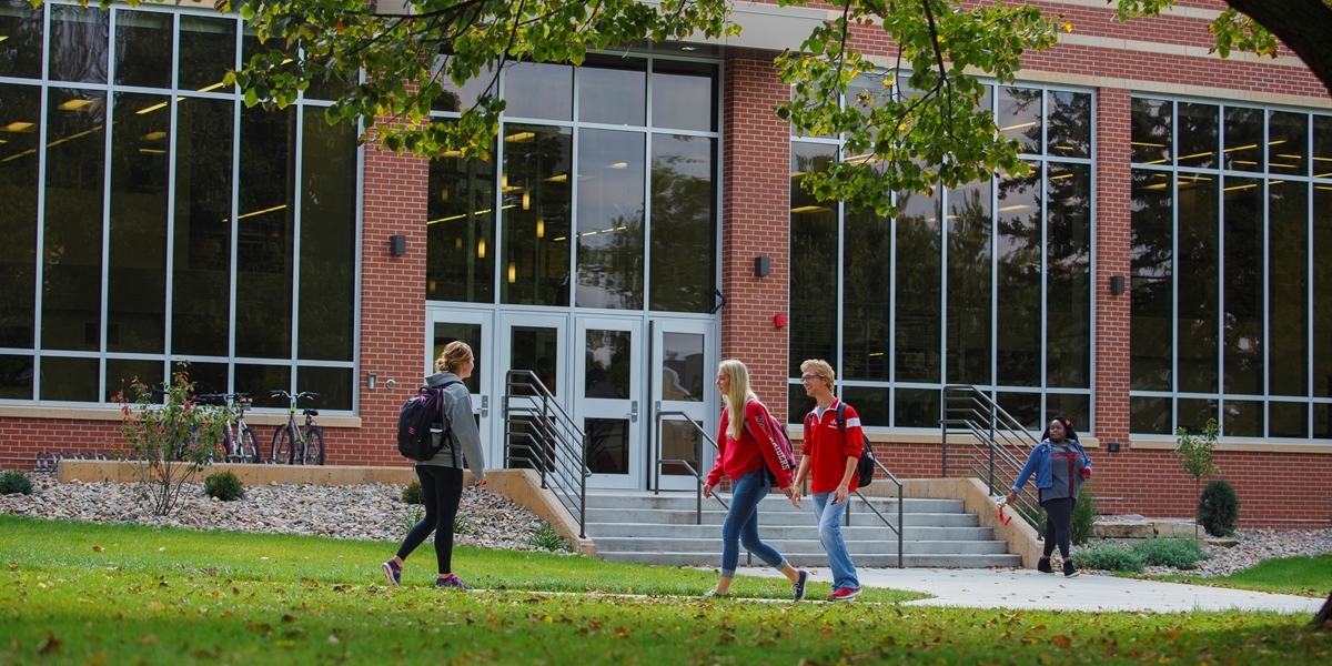 Students walk across the campus green.