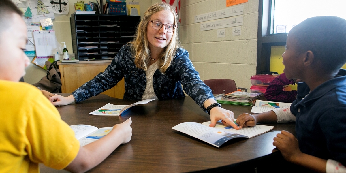 A Northwestern student teacher helps students during her experience in Denver.