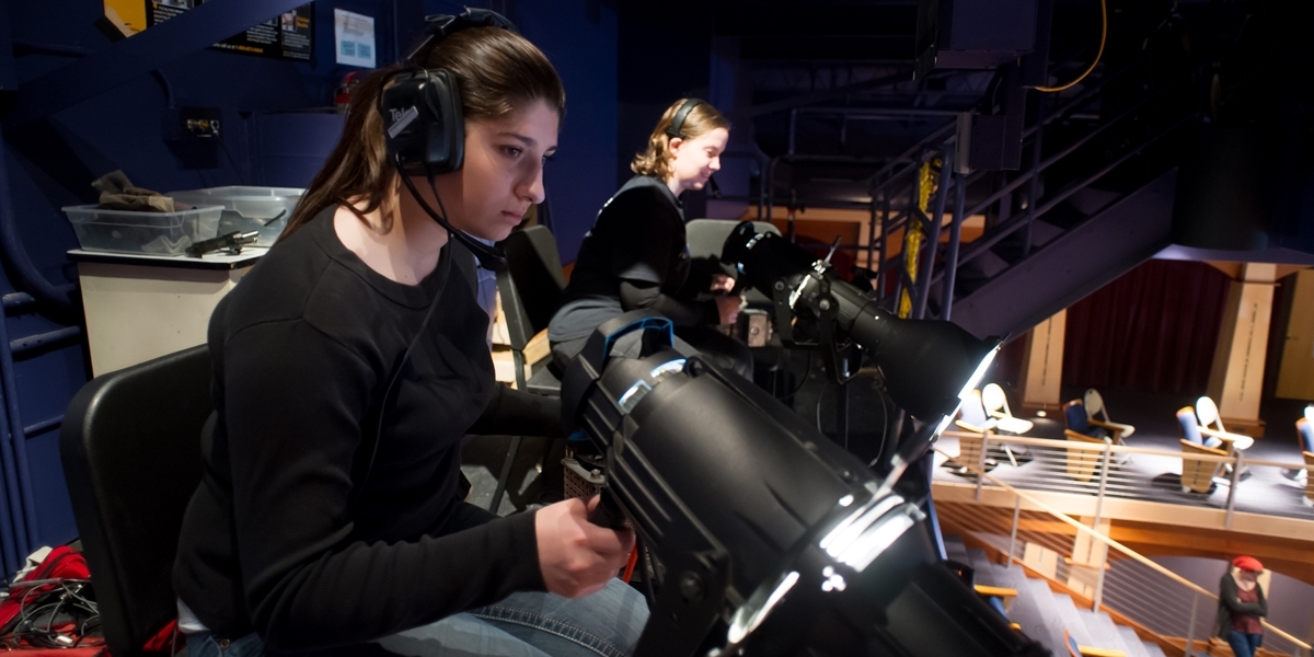 Northwestern students run lights during a theatre production.