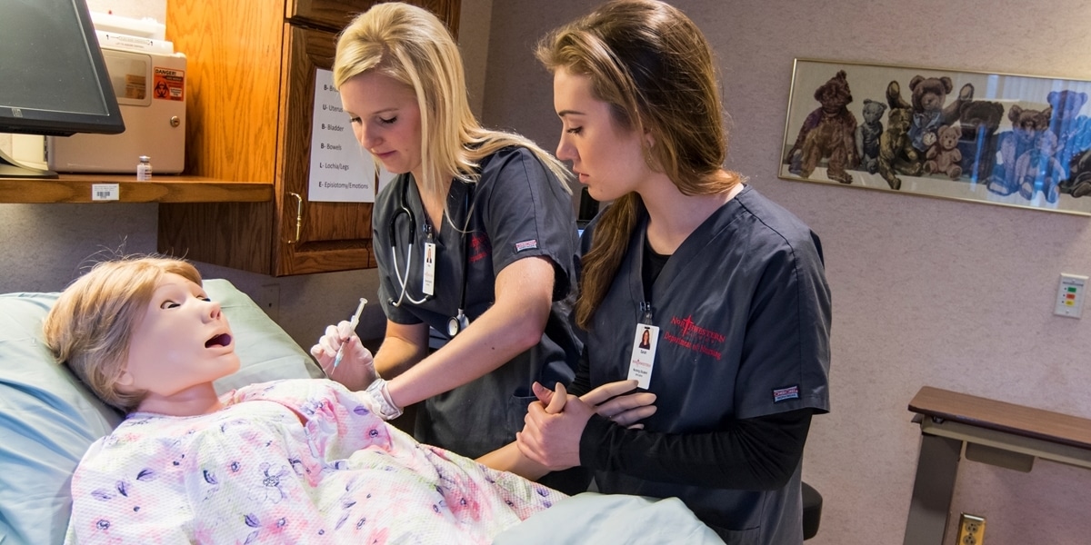 Northwestern nursing students administer medication to a patient simulator.