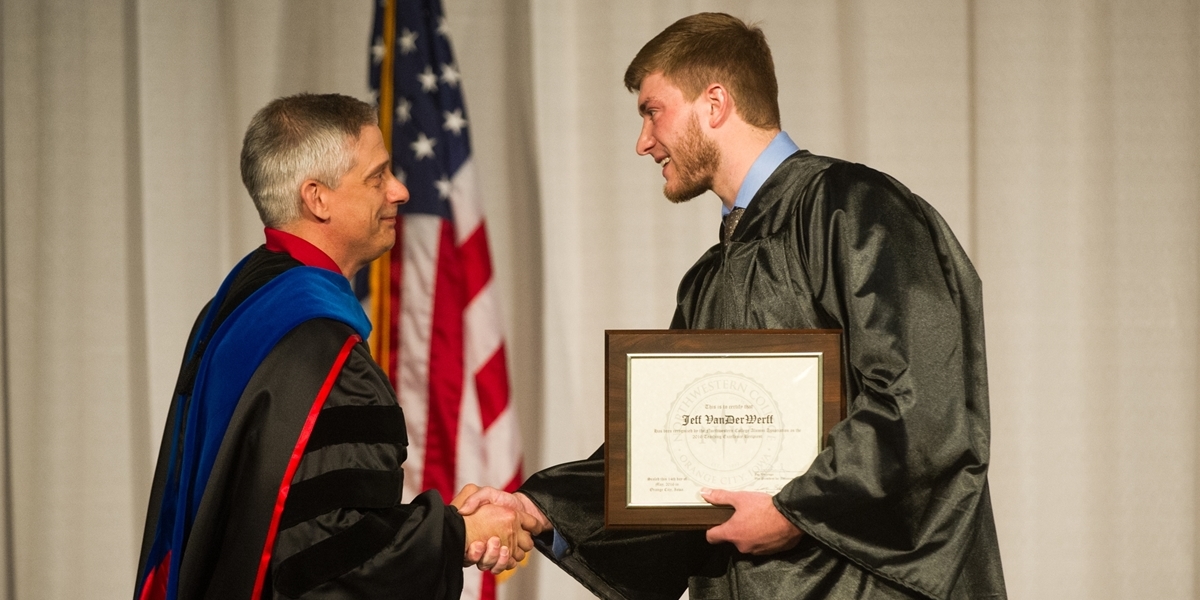 Political science professor Jeff VanDerWerff accepts the Northwestern Teaching Excellence Award.