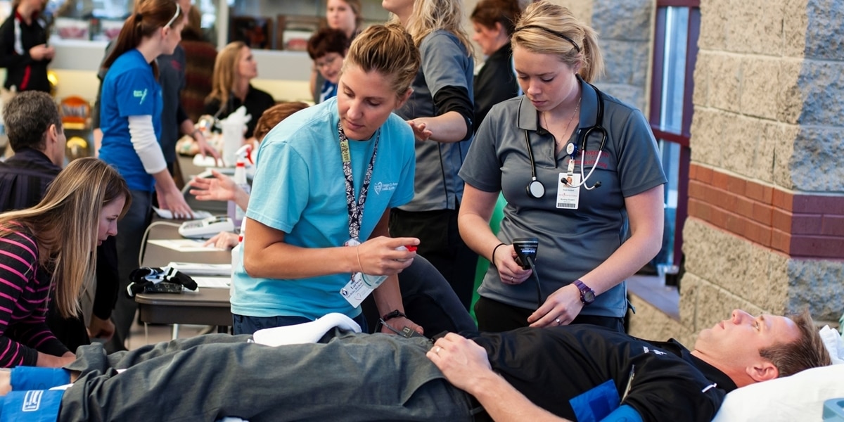 Northwestern nursing students assess a patient during a health and wellness fair.