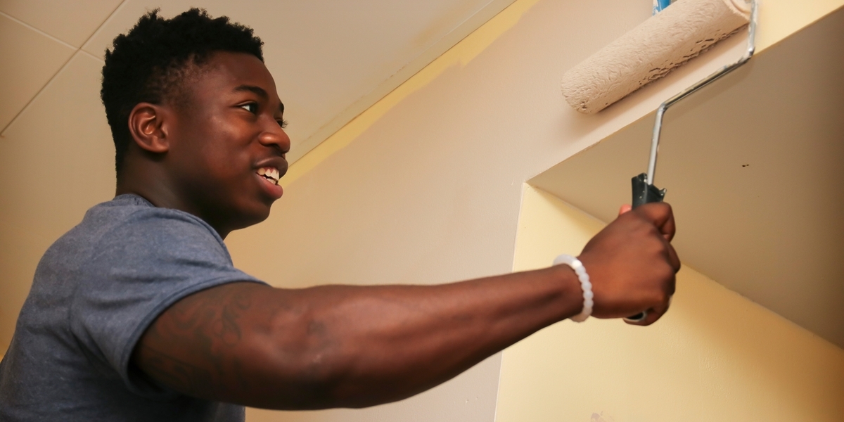 A student paints in a local transitional housing facility.