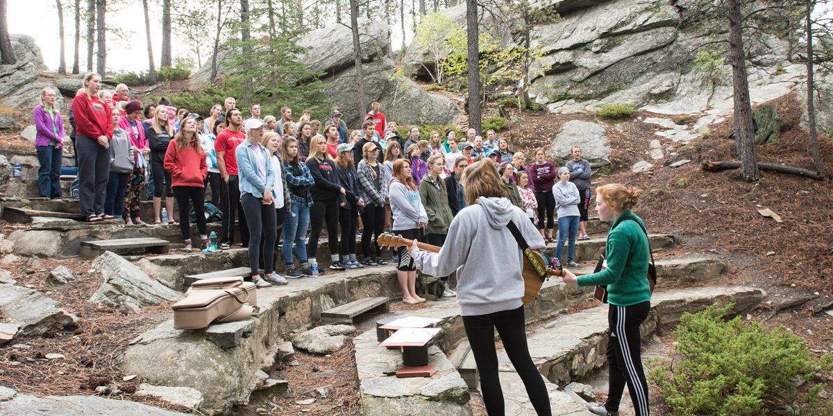 Northwestern College students worship in the Black Hills during a fall retreat.