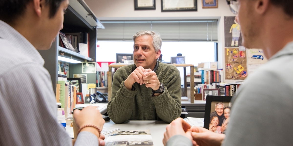 A Northwestern professor meets with students in his office.