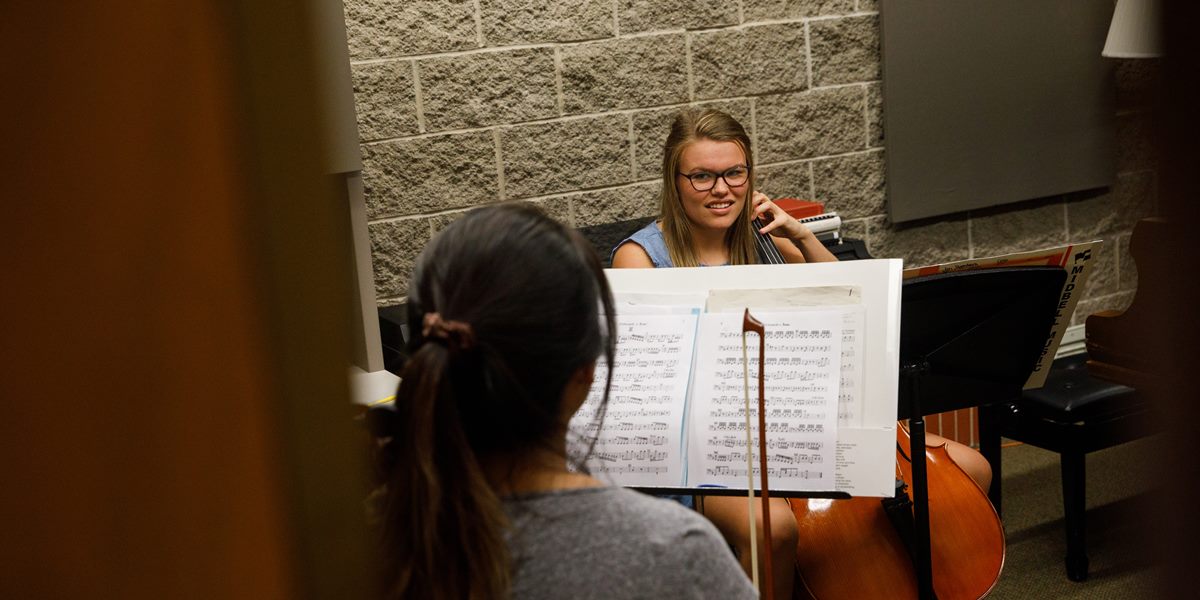 Orchestra members rehearse in a practice room of  DeWitt Music Hall.