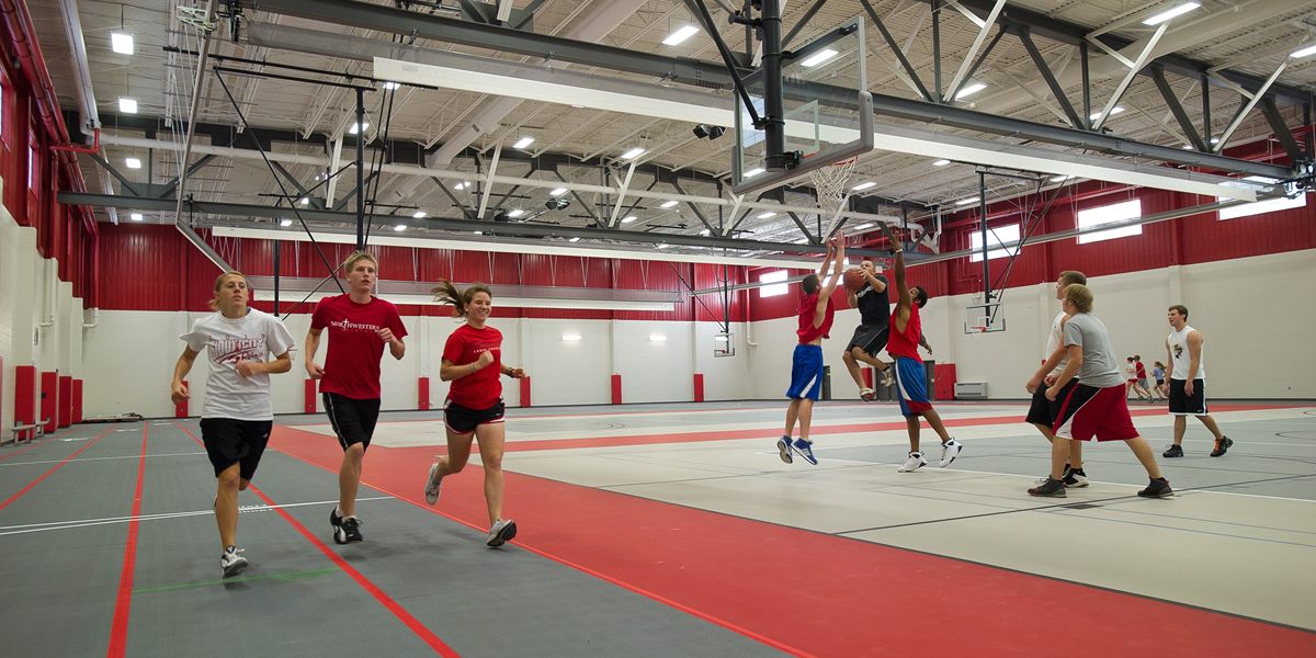 Students run around the indoor track.