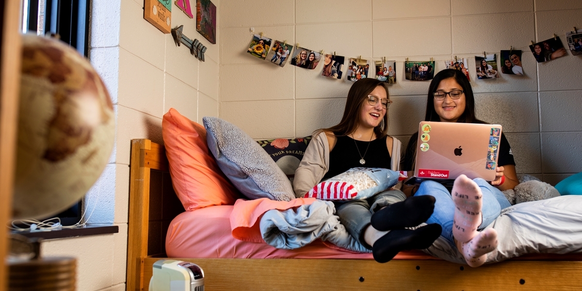 Students talking in a Fern Smith Hall dorm room