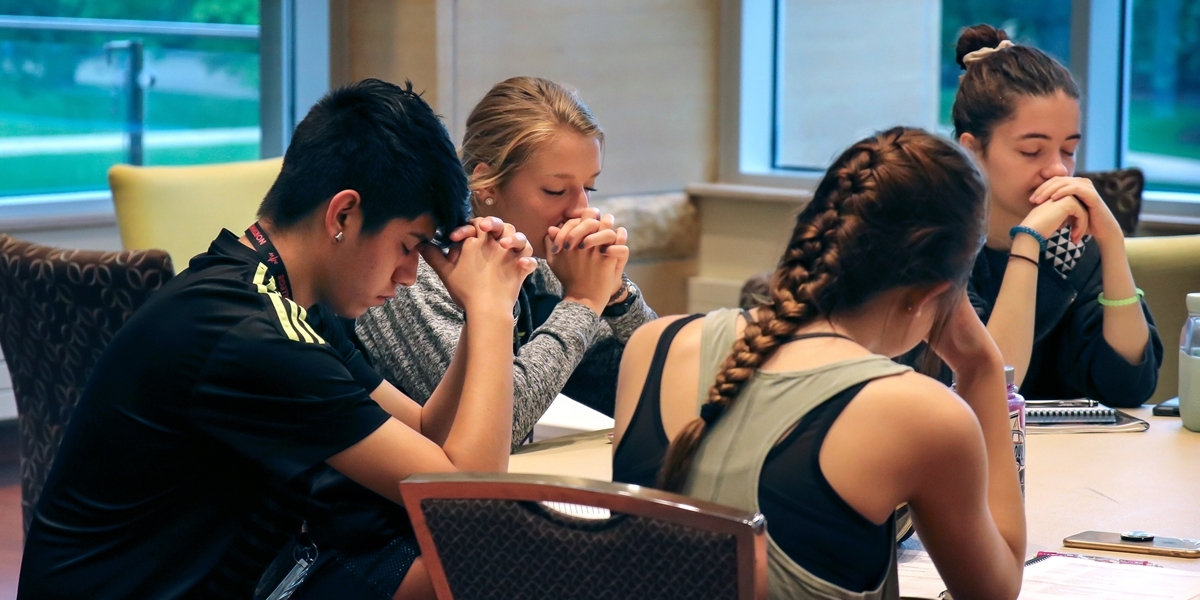 Northwestern College students pray.