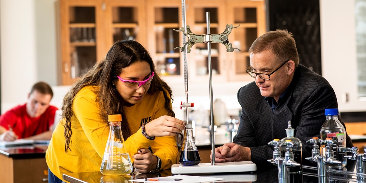 Chemistry professor and student work in the lab.