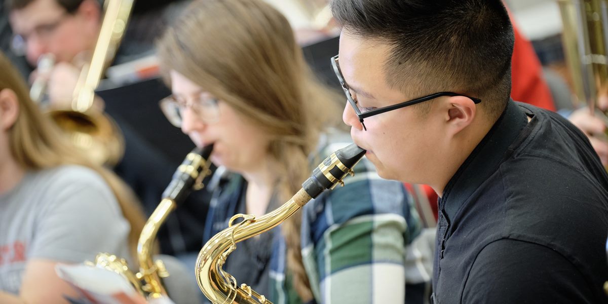Saxophonists perform during a Symphonic Band rehearsal.