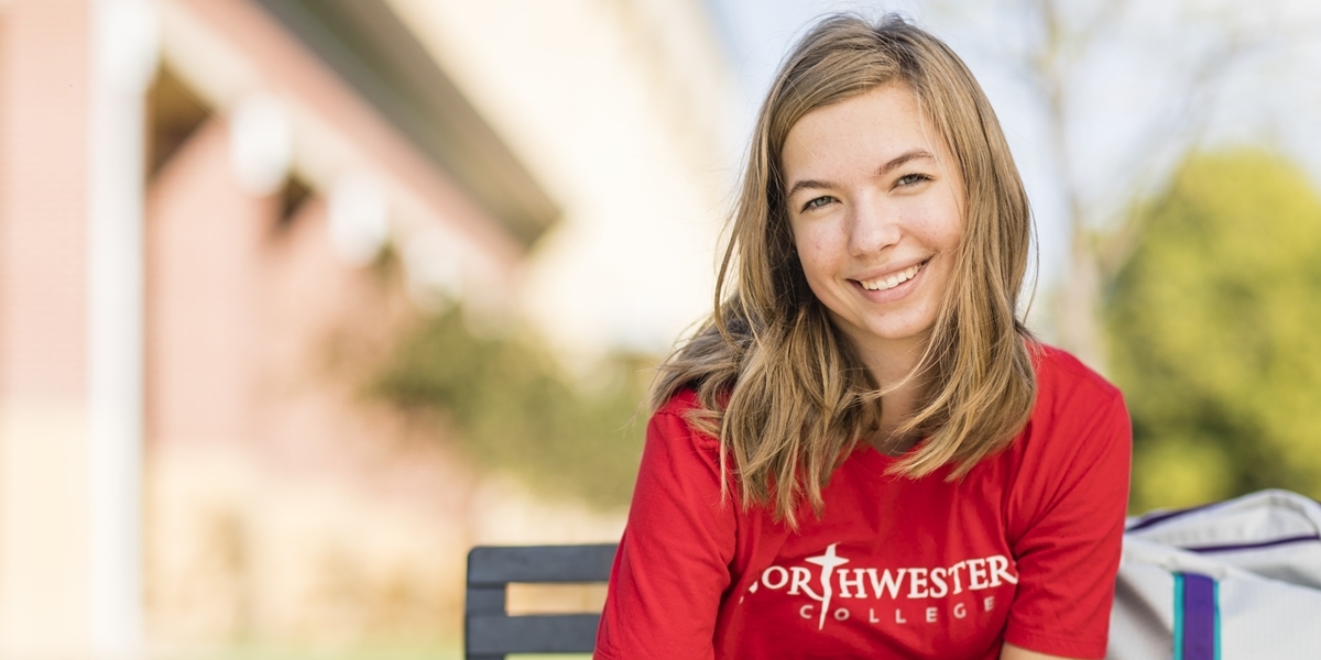 Student sitting outside on bench