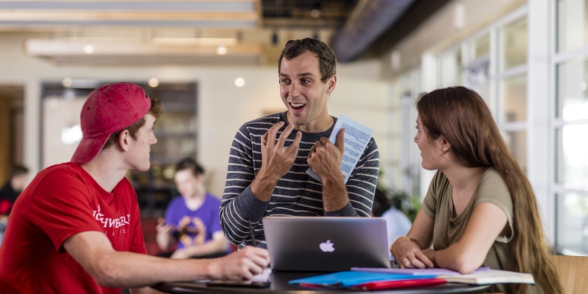 A Northwestern professor talks with students.