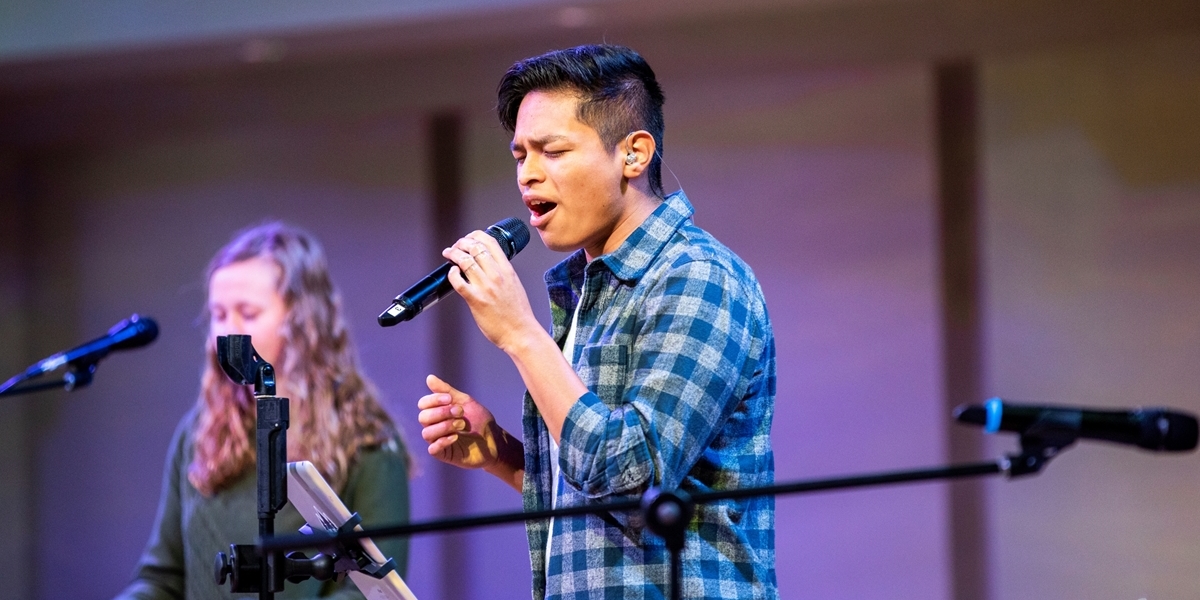 A student leads worship during a Northwestern chapel service.