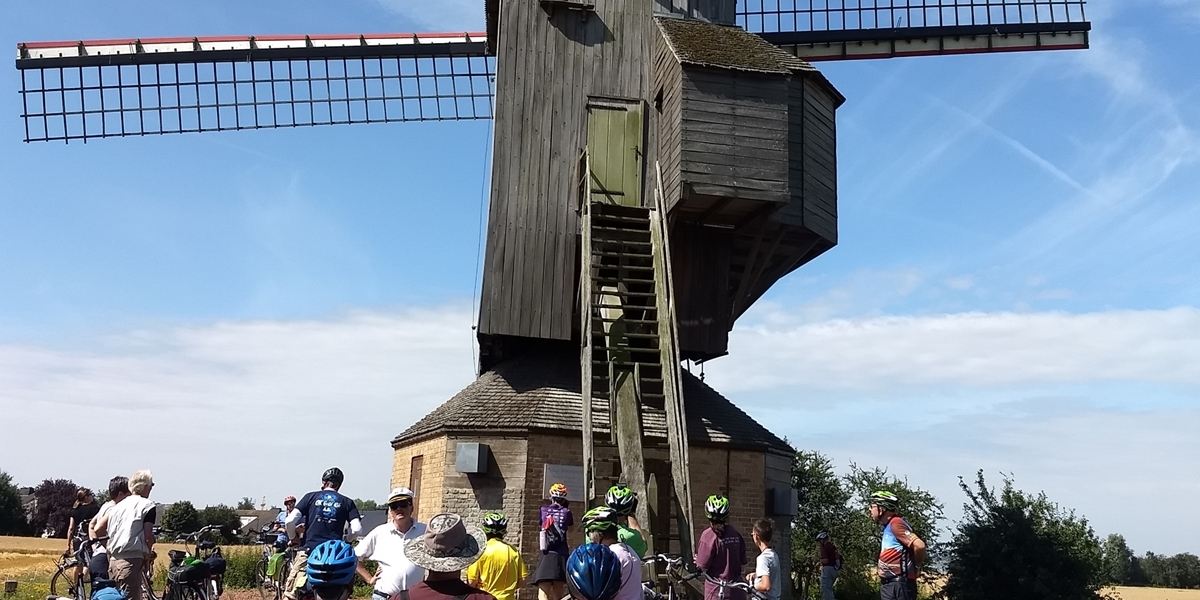 Netherlands bike tour group leader Dr. James Kennedy shares the history of an old windmill.